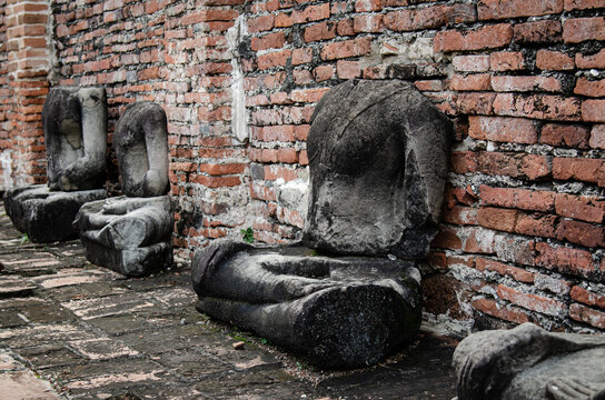 Ruins of Buddha statues in ancient sites, The ruins of the Buddha statue stolen by criminals, Famous tourist attraction in Ayutthaya Thailand.