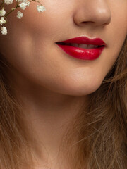 Close-up shot of sexy woman's lips with red lipstick and clean skin. Beautiful spa portrait with a snow-white smile. Spa and cosmetics, dentistry and cosmetology