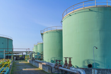 View of storage tank and pipes of chemical industry, Italy