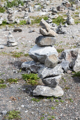 Fototapeta na wymiar Stone cairns on the ground of former marble quarry