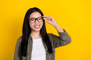 Portrait of good mood intelligent businesswoman working in modern company isolated on yellow color background