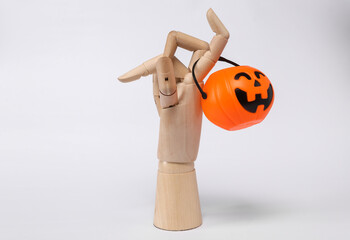 Wooden hand with halloween jack pumpkin bucket isolated on white background. Trick or Treat