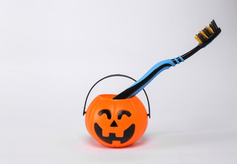 Halloween bucket with toothbrush isolated on white background