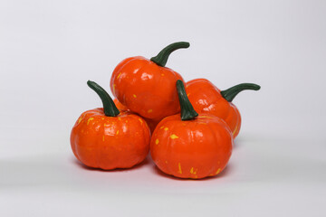 Plastic toy pumpkins isolated on white background