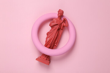 Antique pink statue venus with a circle on a pink background. Minimal still life