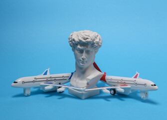 Travel, voyage concept. Passenger plane with david bust on a blue background