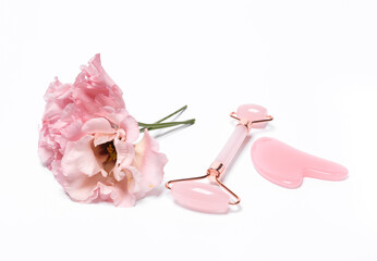 Massage facial roller and a stone with flower on white background. Beauty, facial skin care concept