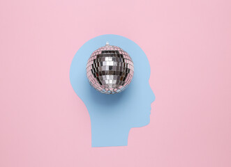 Paper cut human head with disco ball on pink background. Party concept