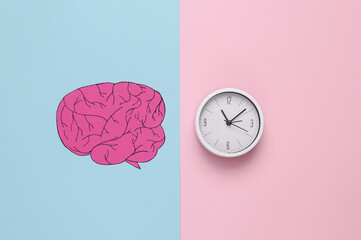 Paper-cut human brain with clock on pink blue background