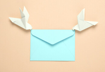 Origami carrier pigeons with envelope on yellow background