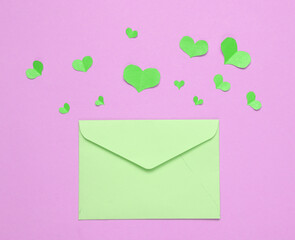 Paper Cut green hearts and envelope on pink background. Valentines day concept