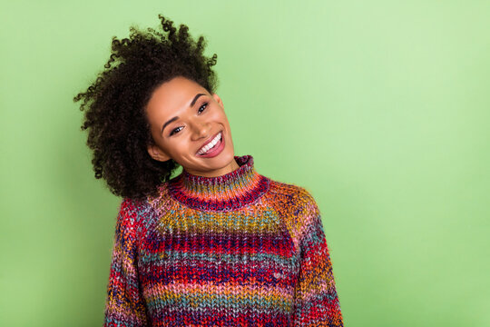 Photo of impressed young valume hairdo lady wear colorful sweater isolated on green color background