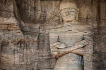 Fototapeta na wymiar Beautiful stone Buddha statues seen in the ancient city of Polonnaruwa, Sri Lanka.
