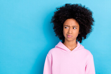 Portrait of attractive bushy haired skeptic girl looking aside copy space no isolated over bright...