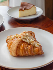 Almond Croissant on the white round plate.