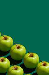 Pattern of green apples on a solid green background