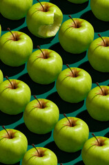 Pattern of green apples on a solid green background