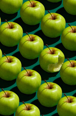 Pattern of green apples on a solid green background