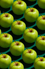 Pattern of green apples on a solid green background
