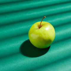 Pattern of green apples on a solid green background