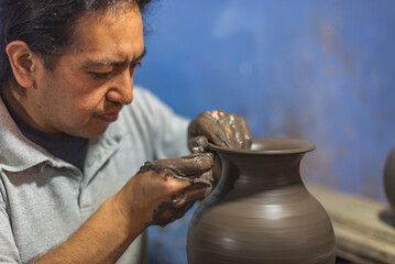Latin craftsman creating a vase of clay for the talavera process