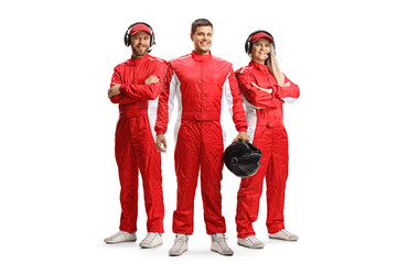Racer and members of a racing team in red overall suits posing and looking at camera