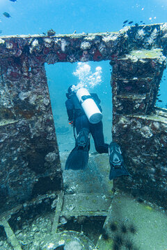 diver exploring the wreck of the HTMS Sattakut in Thailand