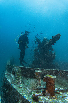diver exploring the wreck of the HTMS Sattakut in Thailand