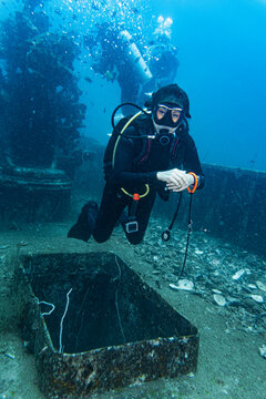 diver exploring the wreck of the HTMS Sattakut in Thailand
