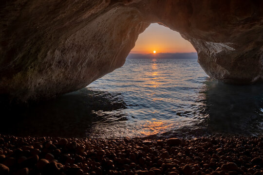 Kako Lagadi cave against sun rising on the horizon, Kefalonia, Greece