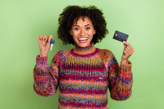 Photo of hooray millennial wavy hairstyle lady hold card key wear red sweater isolated on green color background