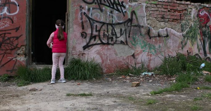 No war in Ukraine. girl near a destroyed house in Ukraine.