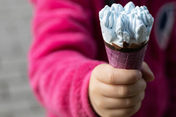 children's hand with ice cream - obrazy, fototapety, plakaty