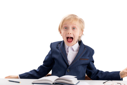 Screaming Fidget Boy In School Uniform. First Grader Boy Fools Around While Performing Lessons. Difficulty Concentrating In Children.