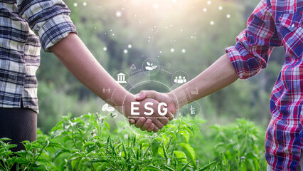 Business man's hand shaking on natural green background with ESG icon concept for environmental,...