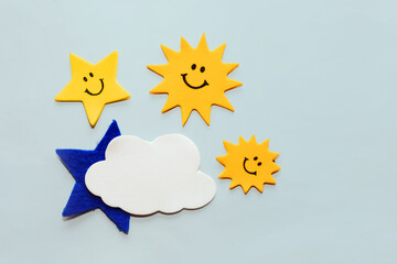 Application of felt stickers star with a smile and clouds on a white background.