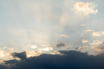Naklejka na ściany i meble Dramatic sunset sky. The rays of the sun at sunset. Cloudy sky with sun rays.