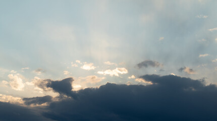 Fototapeta na wymiar Dramatic sunset sky. The rays of the sun at sunset. Cloudy sky with sun rays.