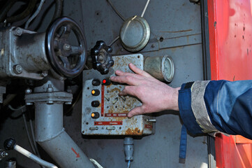 Fireman switching the water pump engine on control panel