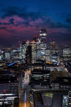 Elevated view of the illuminated Liverpool Street and the City of London during night time © moofushi