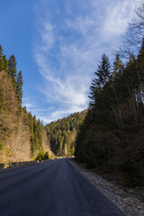 Fototapeta premium Empty road with mountains and blue sky at background.