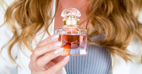 Woman with bottle of perfume. Perfume bottle woman spray aroma. Woman holding a perfumes bottle....