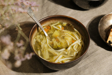 Bowl of vegetable soup on table. Hot meal, healthy vegan dinner.