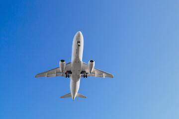 Aviation, travel, air transportation concept. Airplane in blue sky, population evacuation