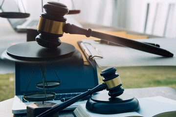 Judge gavel and legal book on wooden table, justice and law concept