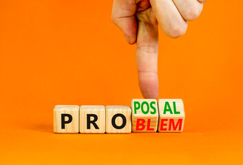 Solving a problem and making proposal symbol. Businessman turns wooden cubes and changes the word Problem to Proposal. Beautiful orange background. Business problem to proposal concept. Copy space.