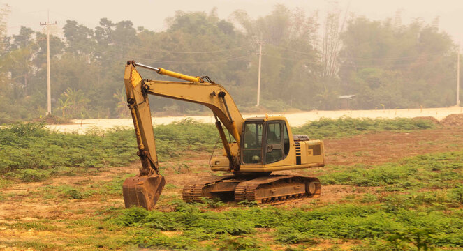 Road construction in Thailand. Road works and road equipment. Excavator operation