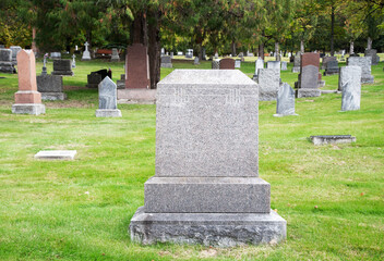 Large blank tombstone and old cemetery. 
