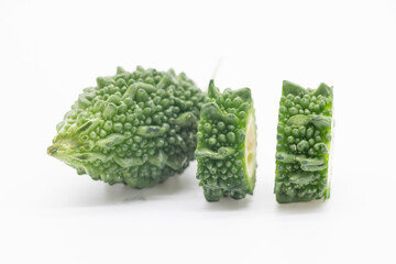 single Bitter melon or Bitter gourd with slice isolated on white background