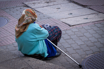 Old woman begging on the street.